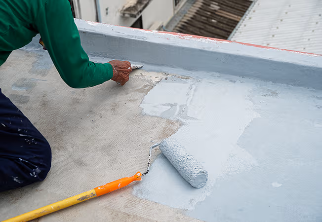 Applying bathroom waterproofing coating to a floor before tiling