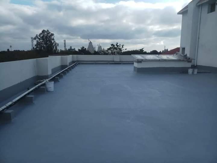 Applying terrace waterproofing coating on a rooftop in Panchkula